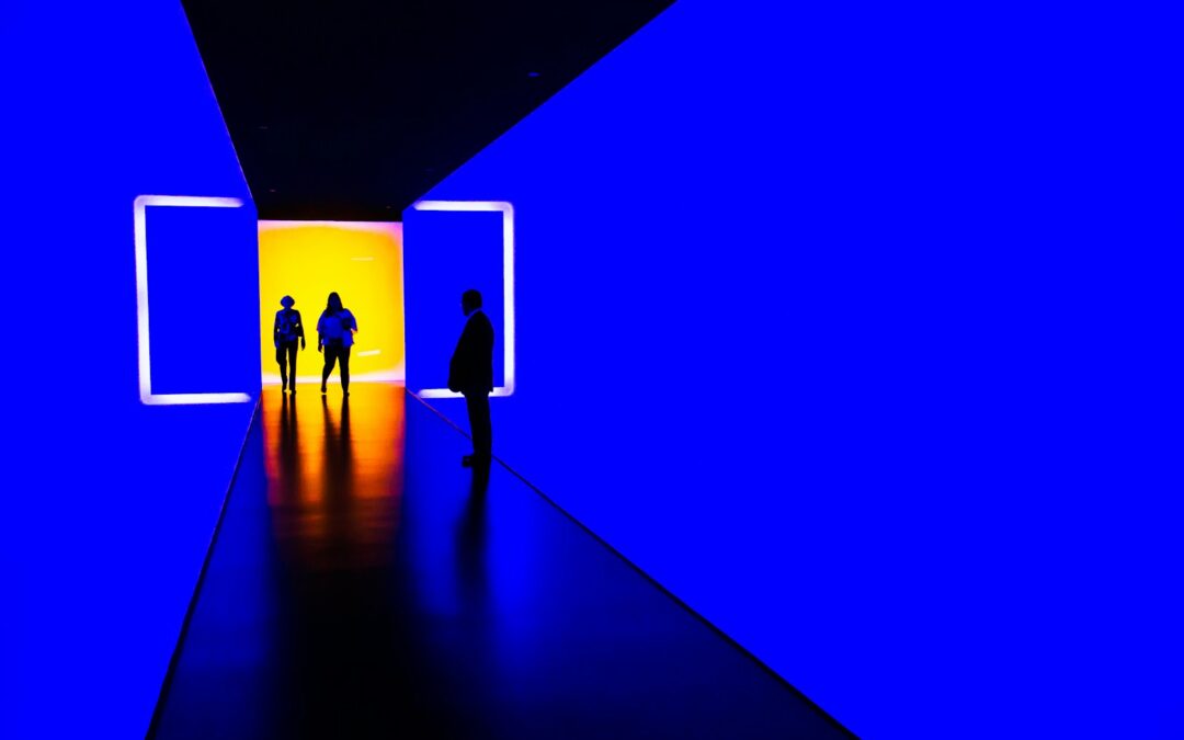 three person standing near wall inside building