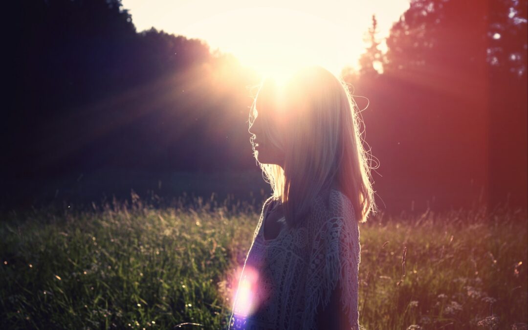 photo of woman on green grass field outdoors during daytime