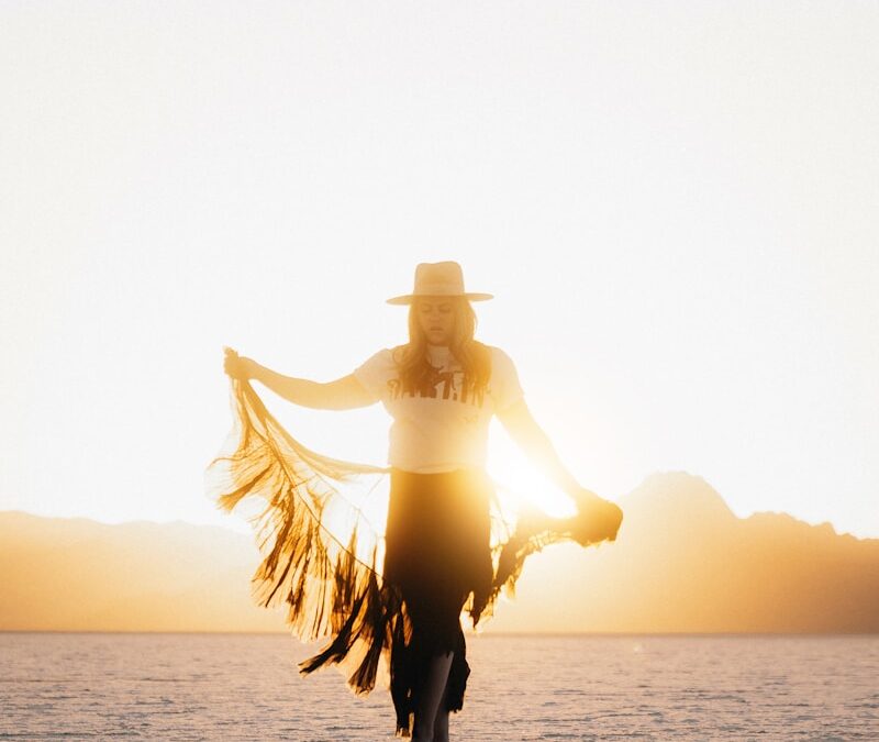 Woman walks toward the camera in the sunset.