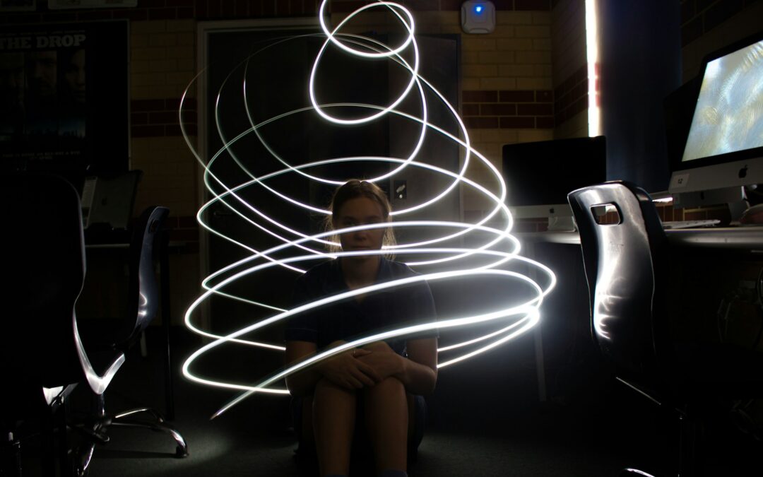 a woman sitting in front of a computer screen