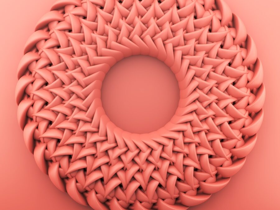 brown round ornament on pink surface